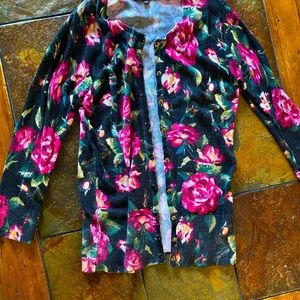 Small over shirt that is black with flowers and a purple sweater.
